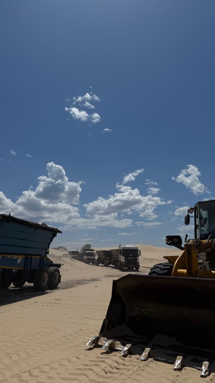 CWG Logistics truck convoy hauling bulk materials across sand dunes